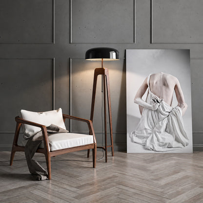 Fungo wood floor lamp casting a soft warm ambient glow over a corner reading chair