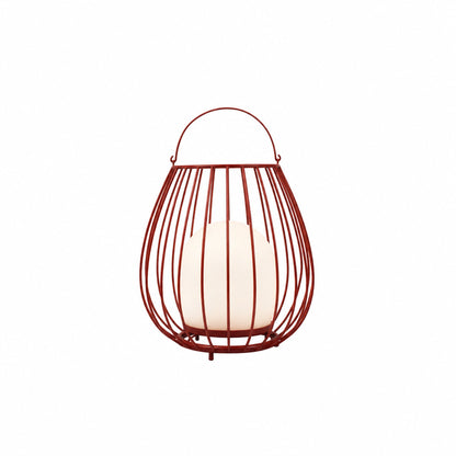 Red Gabbia rechargeable lantern adding a pop of color to a poolside patio at night