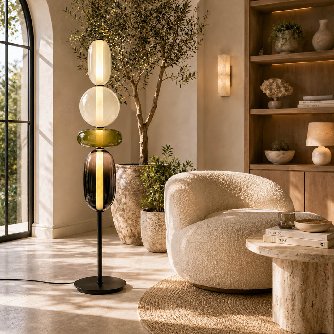 Gemma stacked glass floor lamp Model A green modern reading corner beside armchair hand-blown art glass sculptural warm glow American home lifestyle interior