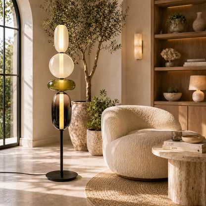 Gemma stacked glass floor lamp Model A green modern reading corner beside armchair hand-blown art glass sculptural warm glow American home lifestyle interior