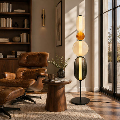 Gemma stacked glass floor lamp Model A green modern reading corner beside armchair hand-blown art glass sculptural warm glow American home lifestyle interior