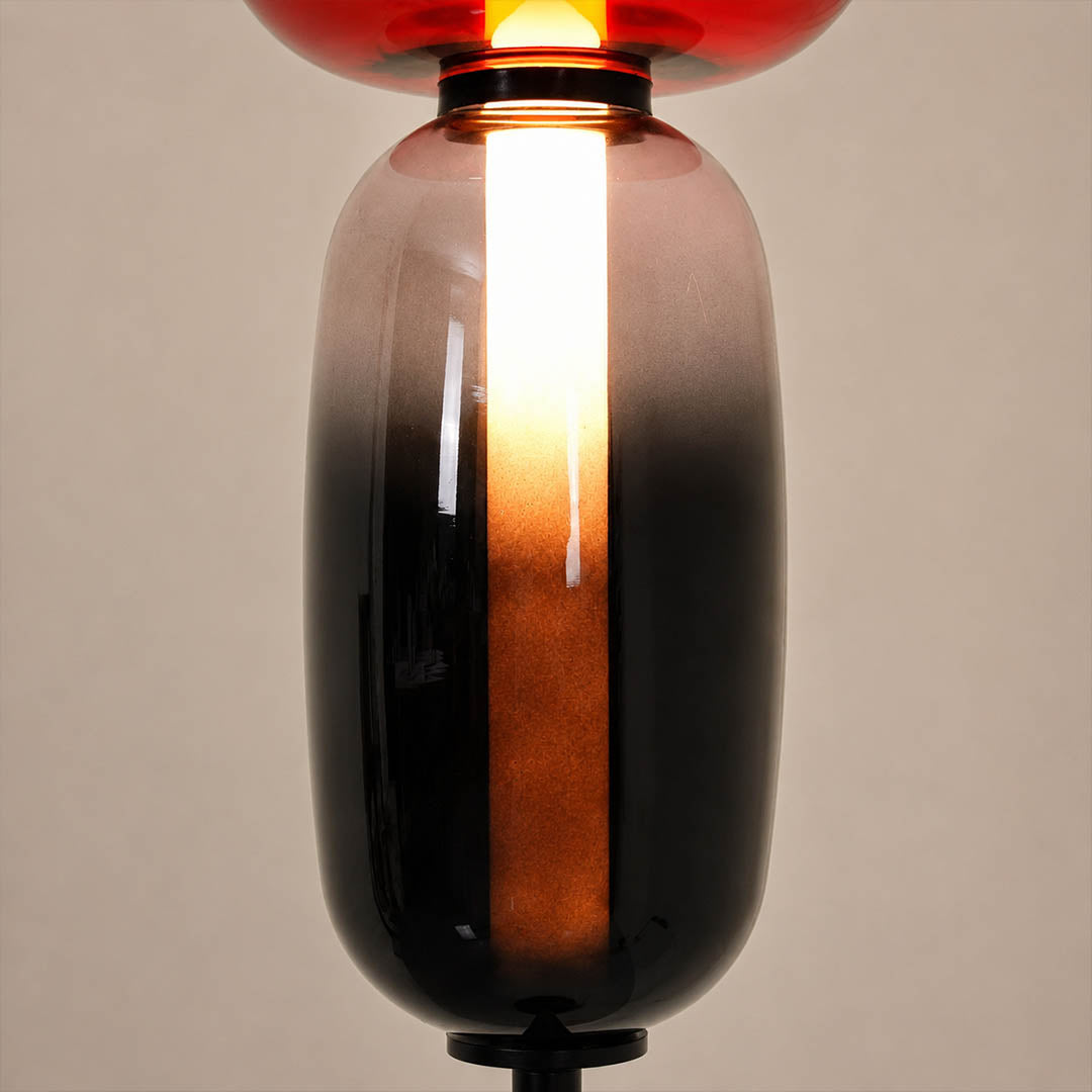Gemma stacked glass floor lamp illuminated glowing hand-blown glass column warm light evening artistic sculptural mood detail close up