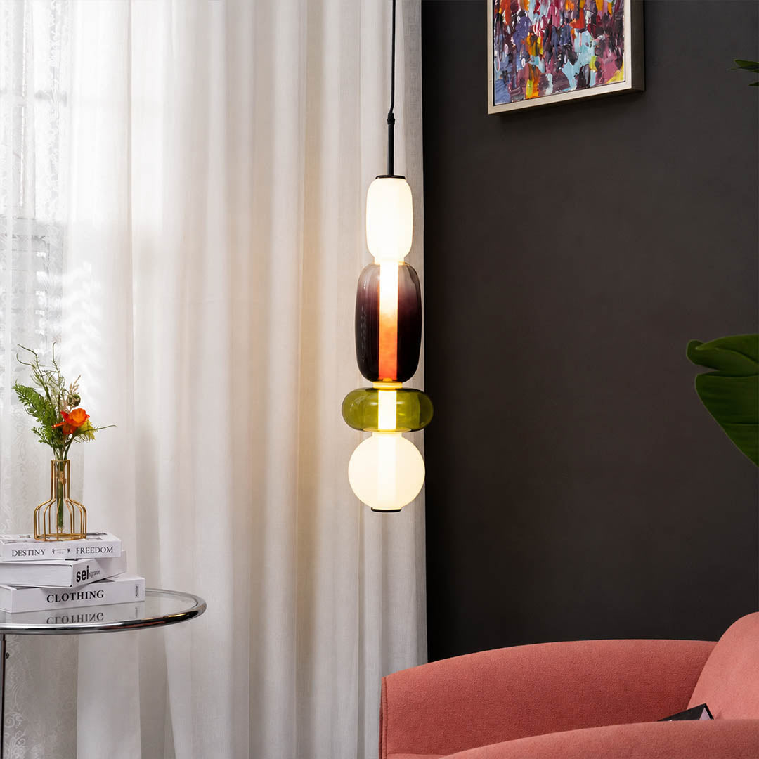 Gemma stacked glass pendant light green smoked single reading corner beside leather chair hand-blown art glass warm glow American home lifestyle interior
