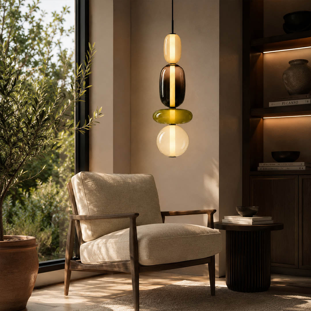 Gemma stacked glass pendant light green smoked single reading corner beside leather chair hand-blown art glass warm glow American home lifestyle interior