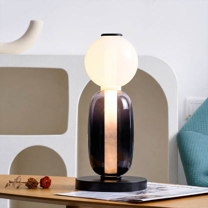 Gemma stacked glass table lamp Model D colorful reading nook beside green armchair hand-blown art glass sculptural warm glow American home lifestyle interior