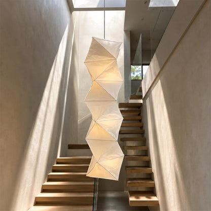 Sunlit modern staircase featuring a sculpted Washi Paper L8 Pendant Light hanging from the ceiling skylight by Stuber Lighting.