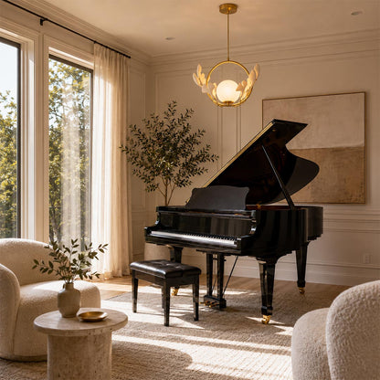 Elegant botanical ginkgo leaf chandelier hanging in a sunny music room with a grand black piano.
