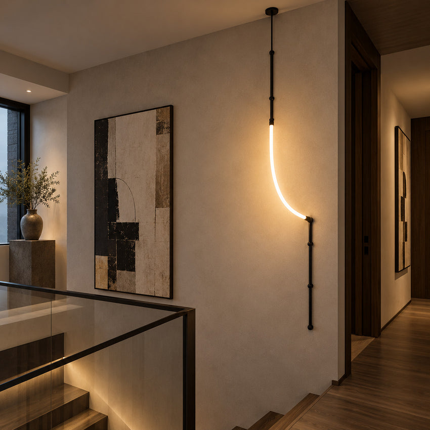 Giunco bamboo pole lamp glowing at the end of a long hallway