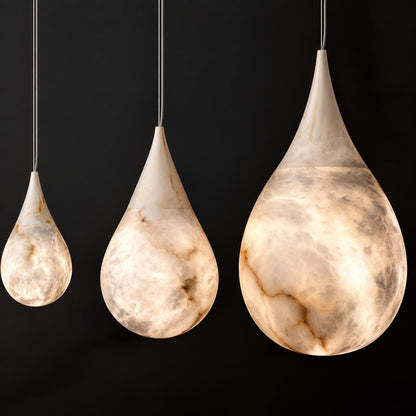 Close-up of the raindrop-shaped natural alabaster shade on the Goccia pendant lit softly from within