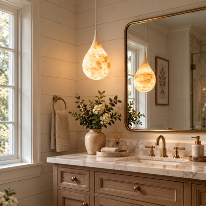 Goccia alabaster raindrop pendant above a vanity mirror in a dry dressing area