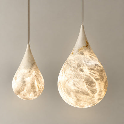 Close-up of the raindrop-shaped natural alabaster shade on the Goccia pendant lit softly from within