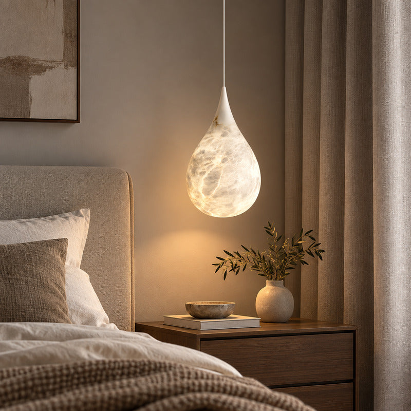 Pair of Goccia alabaster raindrop pendants flanking a bed in place of table lamps