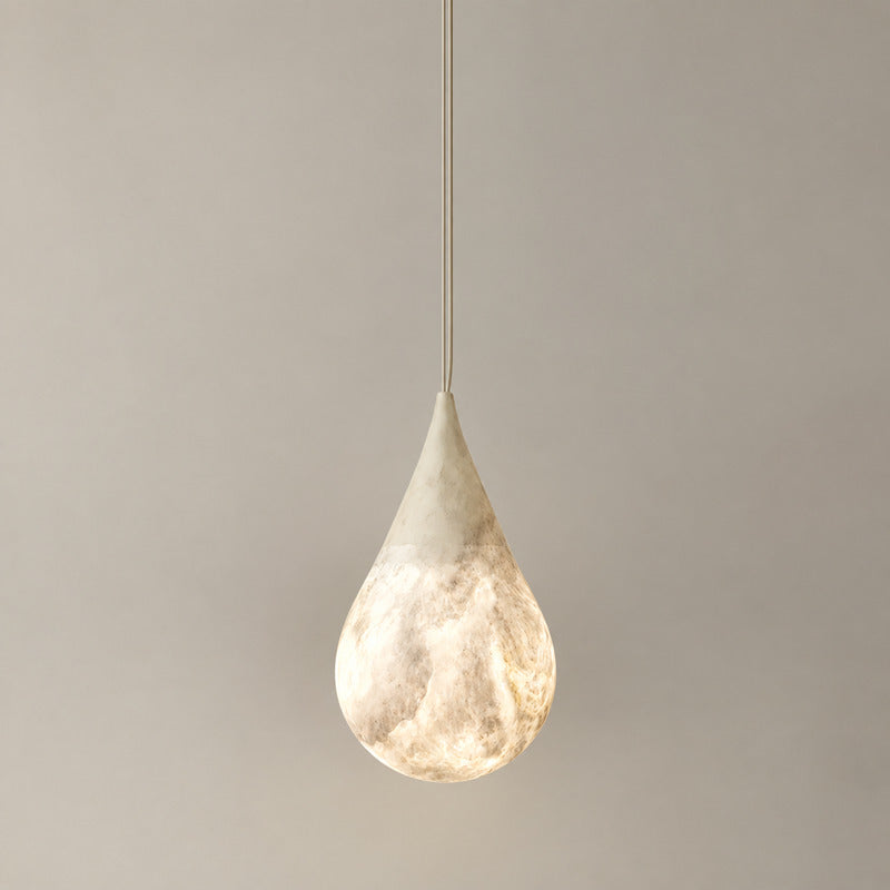 Small 5.9-inch Goccia alabaster raindrop pendant over a breakfast nook or bedside table