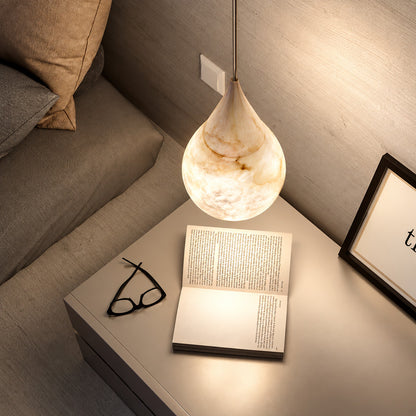 Pair of Goccia alabaster raindrop pendants flanking a bed in place of table lamps