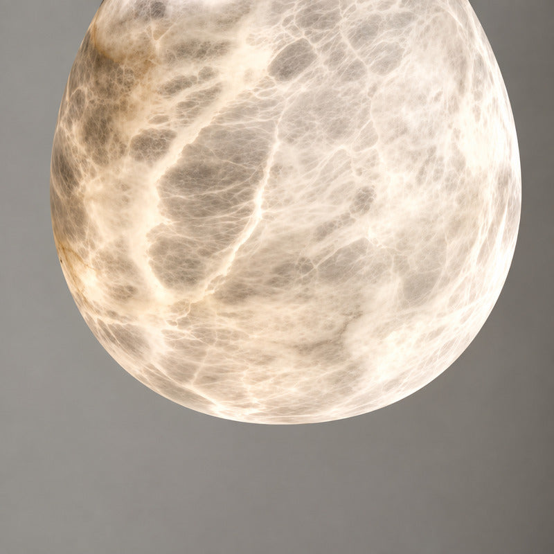 Natural veining and translucency of the alabaster shade on the Goccia pendant, unique to each piece