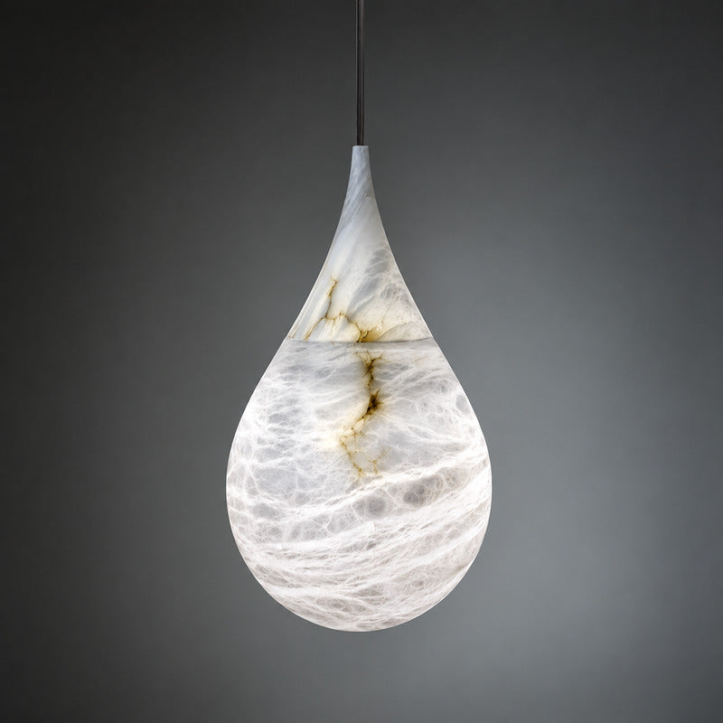 Warm glow diffusing softly through the raindrop alabaster shade of the Goccia pendant