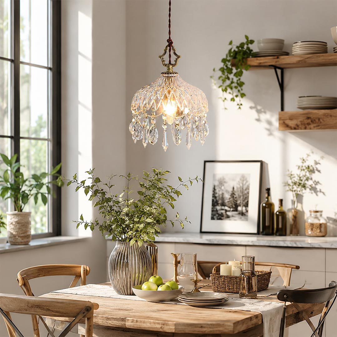 Detailed shot of Goldie brass crystal pendant light, a French vintage style hanging ceiling lamp with clear glass shade and elegant crystal prisms for cozy home decor.