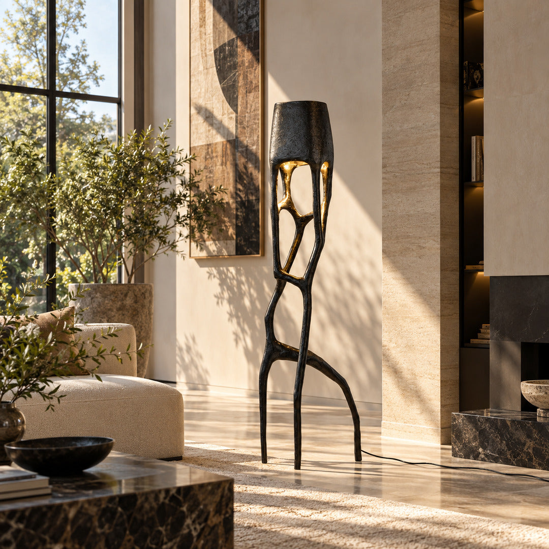 Gotica sculpture floor lamp standing beside a sofa as a dramatic centerpiece in a modern living room