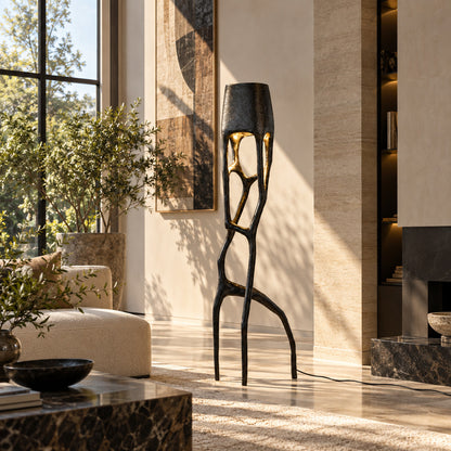 Gotica sculpture floor lamp standing beside a sofa as a dramatic centerpiece in a modern living room