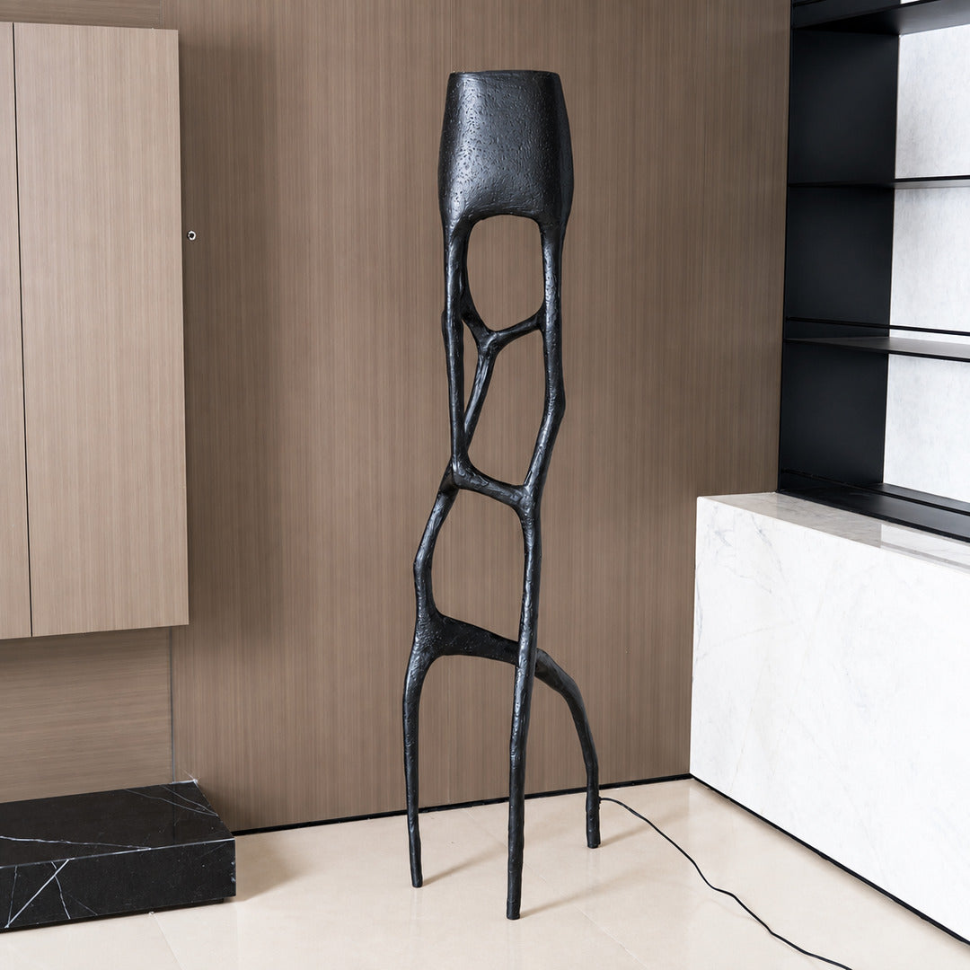 Gotica sculpture floor lamp filling a living room corner with a warm sculptural glow