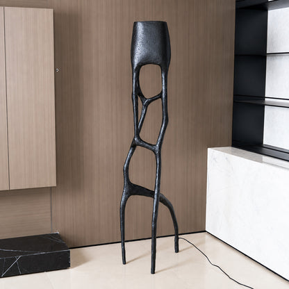 Gotica sculpture floor lamp filling a living room corner with a warm sculptural glow