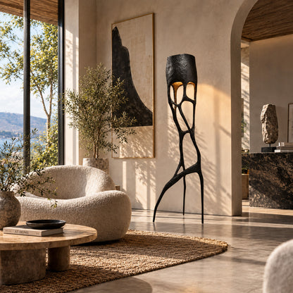 Gotica sculpture floor lamp standing beside a sofa as a dramatic centerpiece in a modern living room