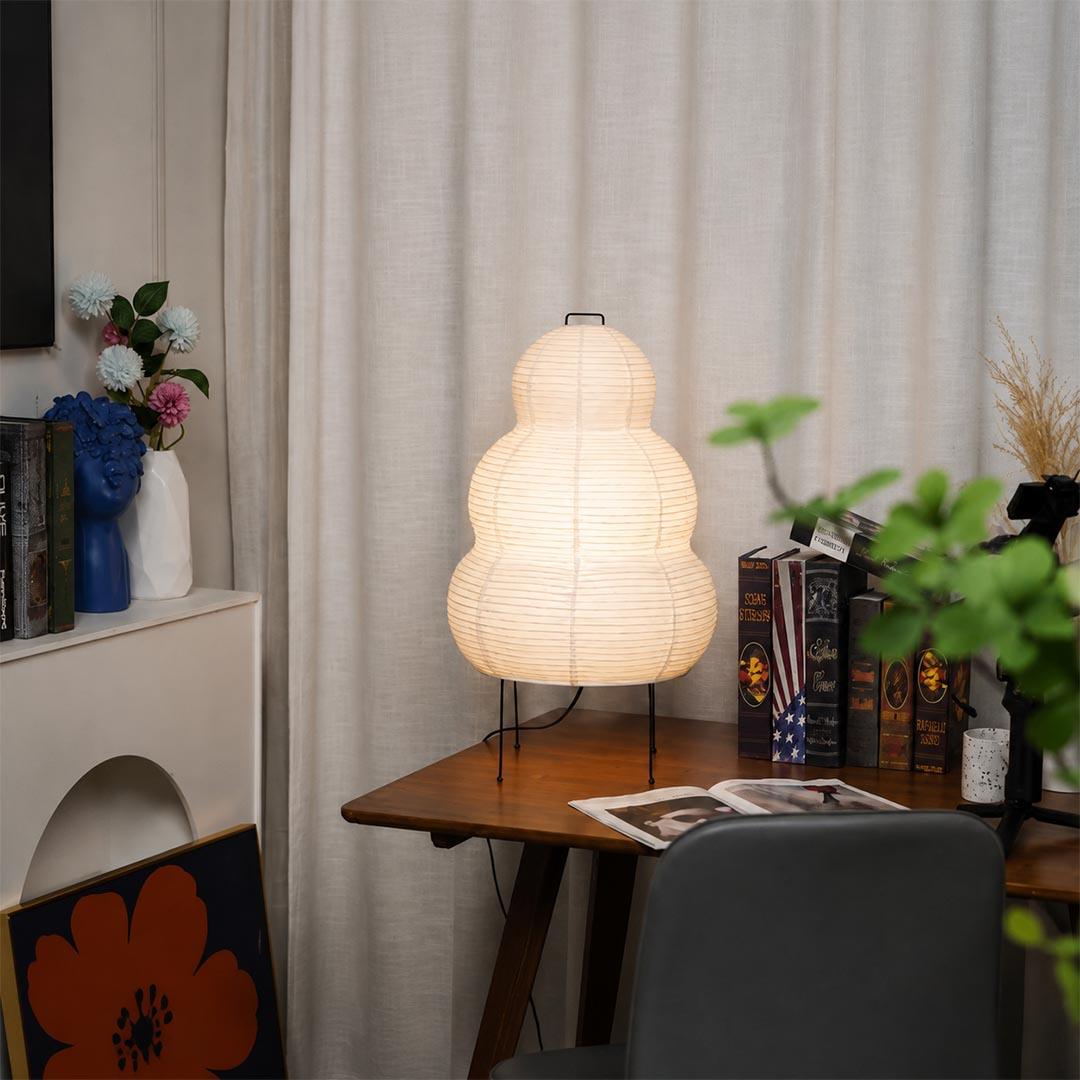 Japanese style 3-tier paper lantern table lamp styled in a cozy study room with plants and wooden furniture