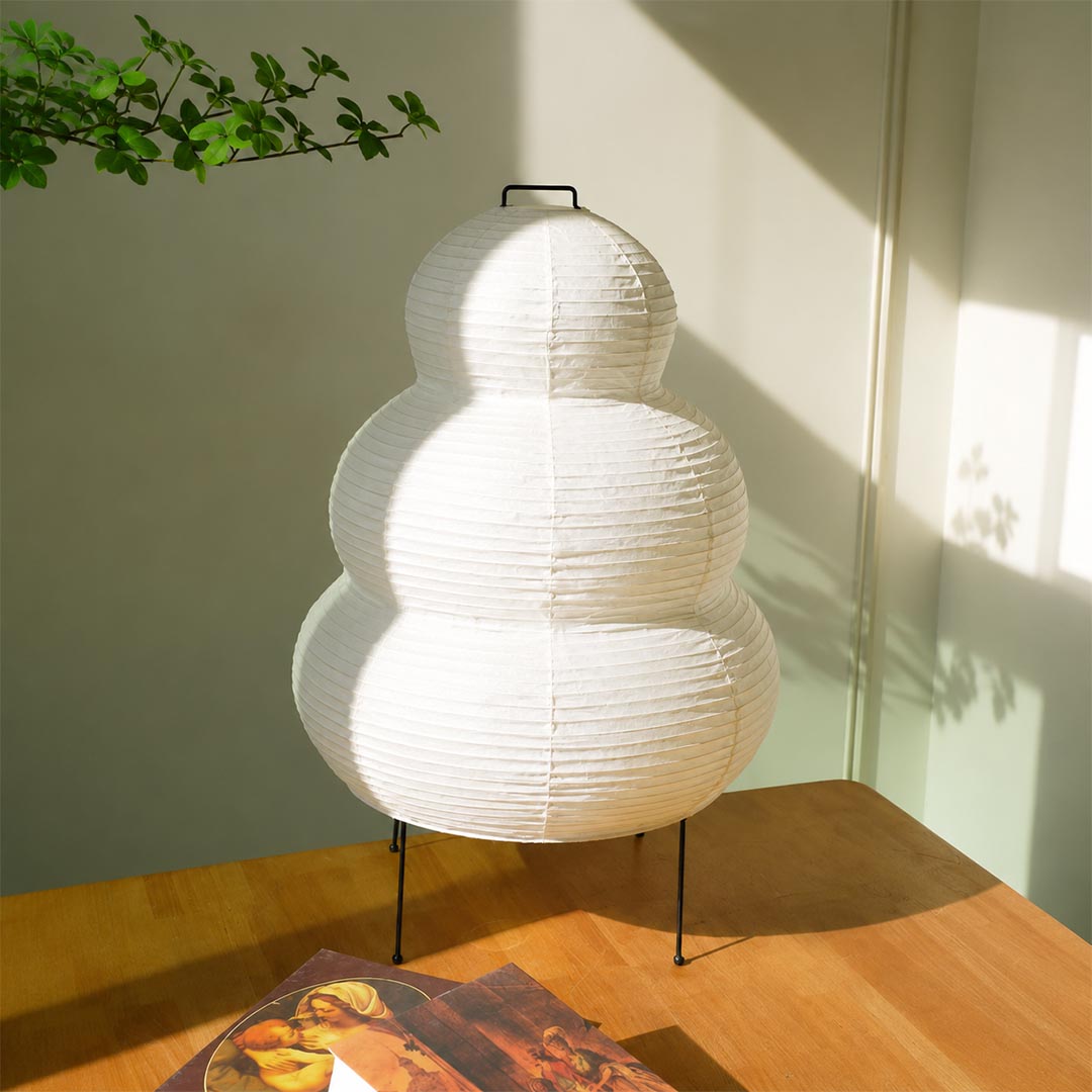 Washi paper gourd lantern table lamp displayed in natural sunlight showing texture and elegant minimalist design