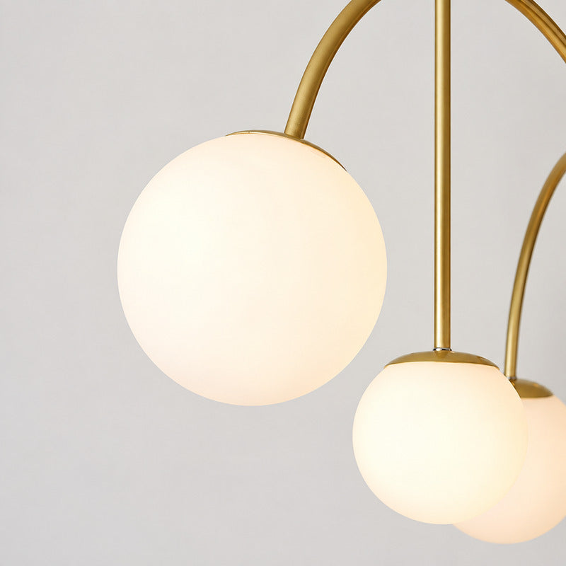 Detail of the white glass globe shades diffusing a soft warm glow on the Gran Finale chandelier