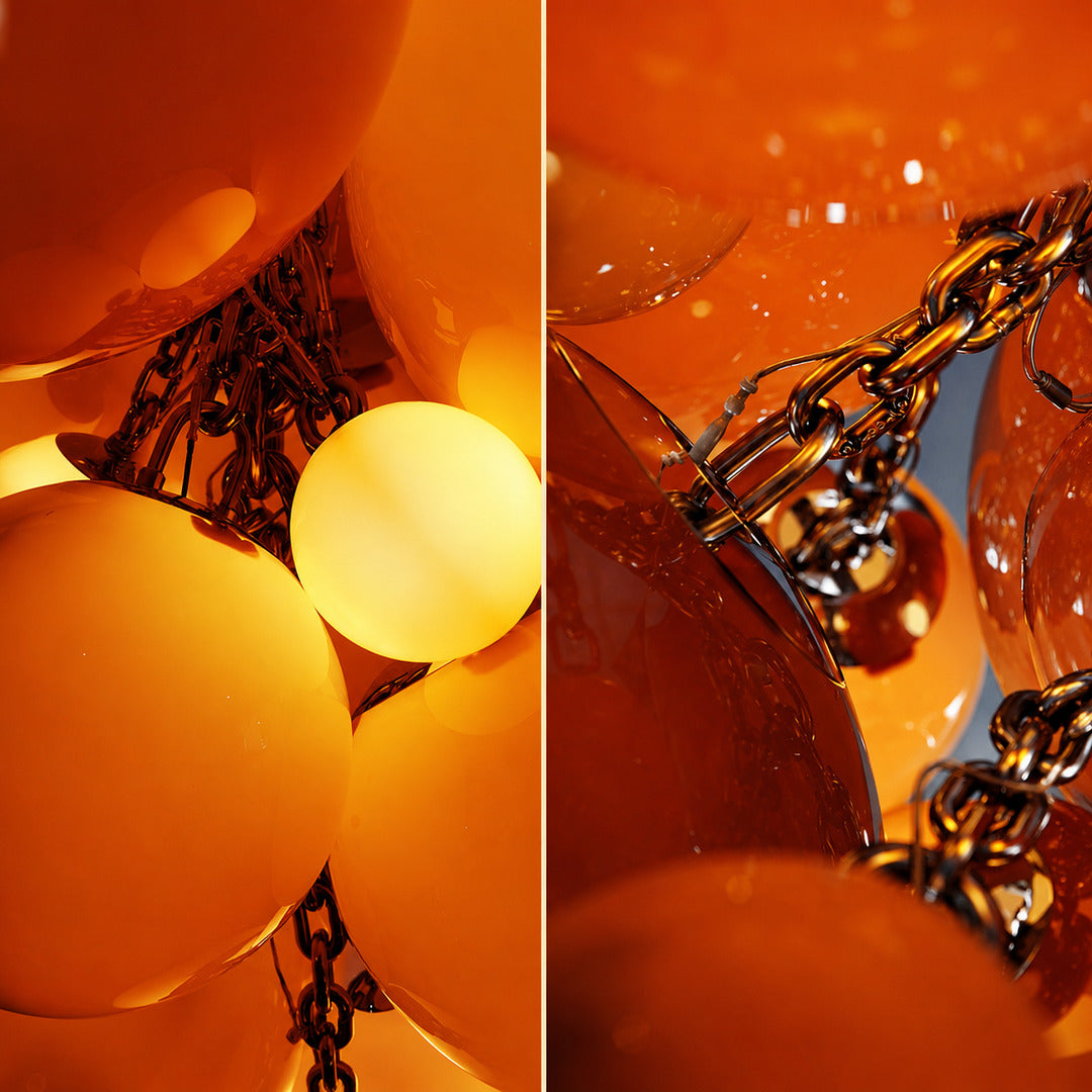 Detail of the chrome frame and chain suspension of the Grappolo glass chandelier