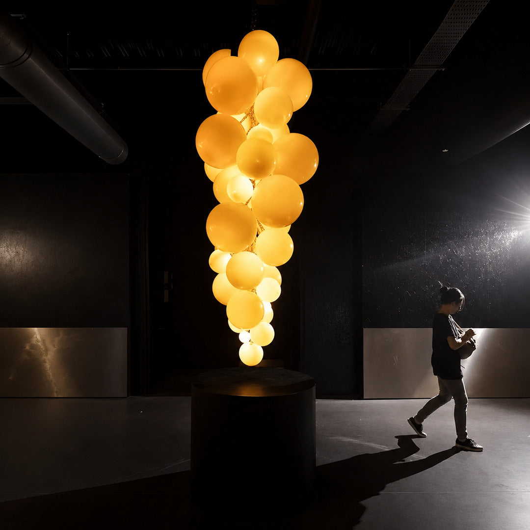 Large Grappolo glass chandelier creating a glamorous overhead centerpiece for an event venue