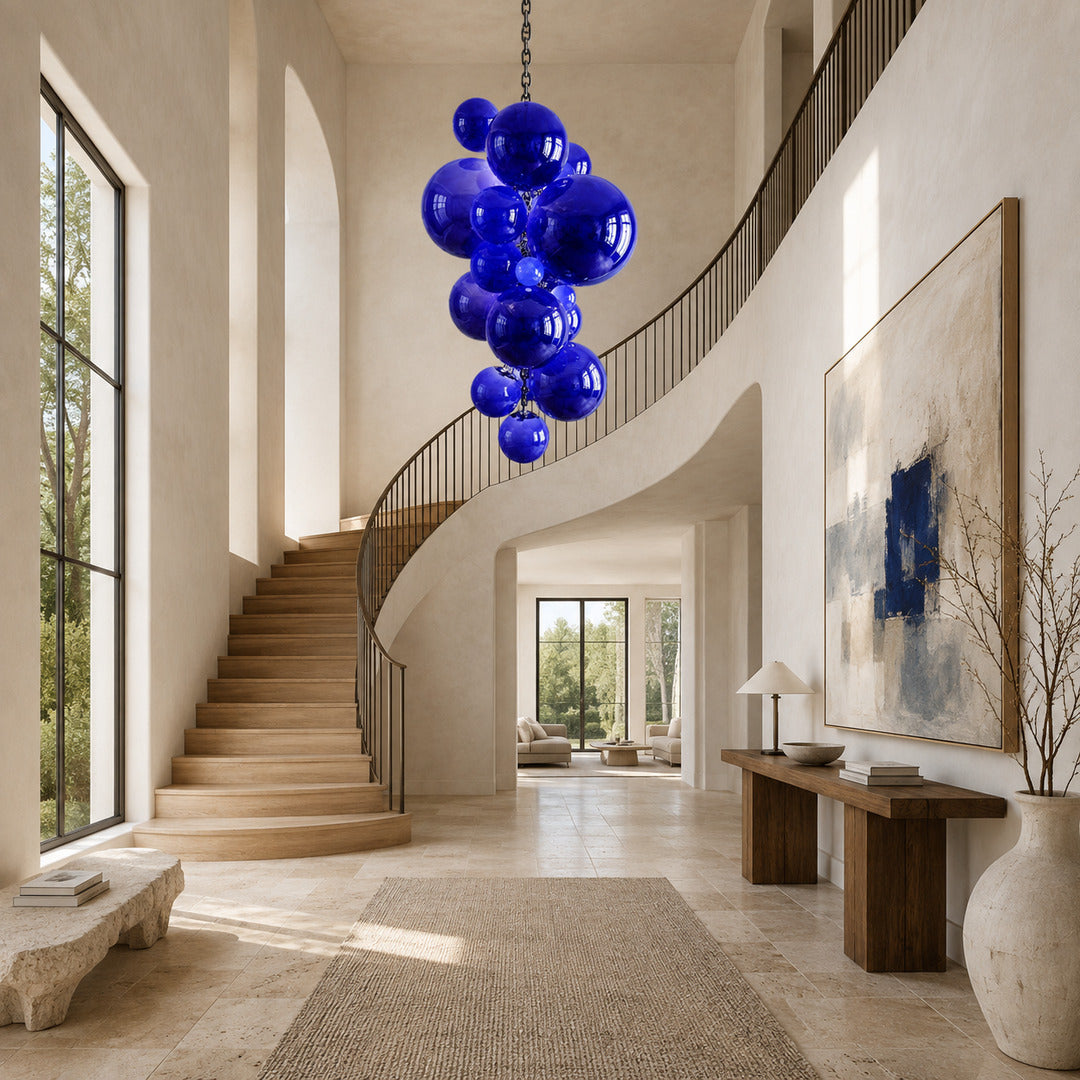 Grappolo glass chandelier flowing down an open staircase stairwell like a cluster of globes