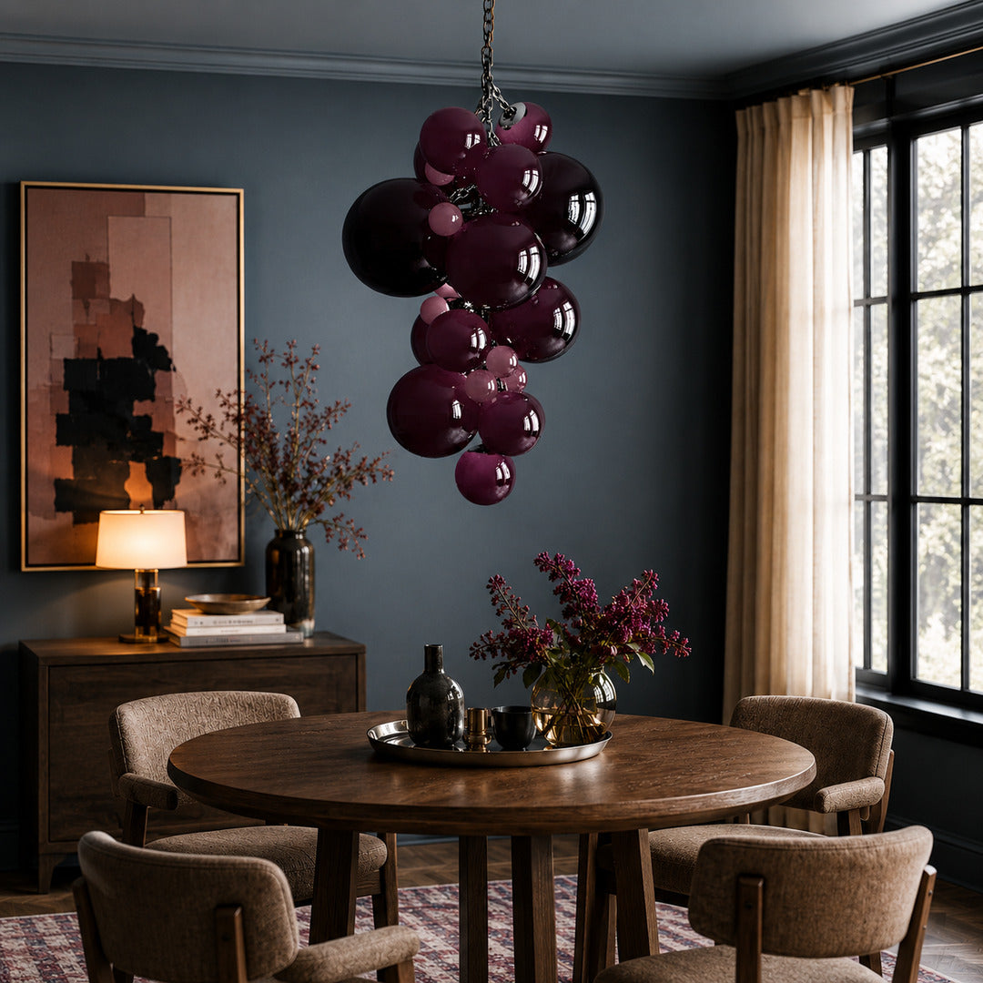Grappolo glass chandelier casting a warm glow over an elegant dining room table