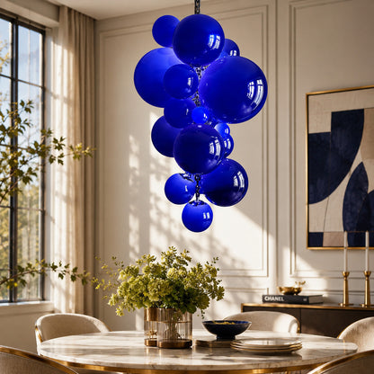 Grappolo glass chandelier casting a warm glow over an elegant dining room table