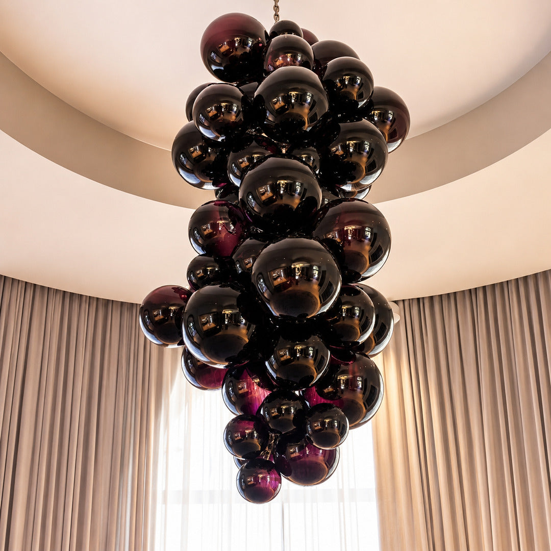 Tall Grappolo glass chandelier cascading in a grand double-height entryway foyer