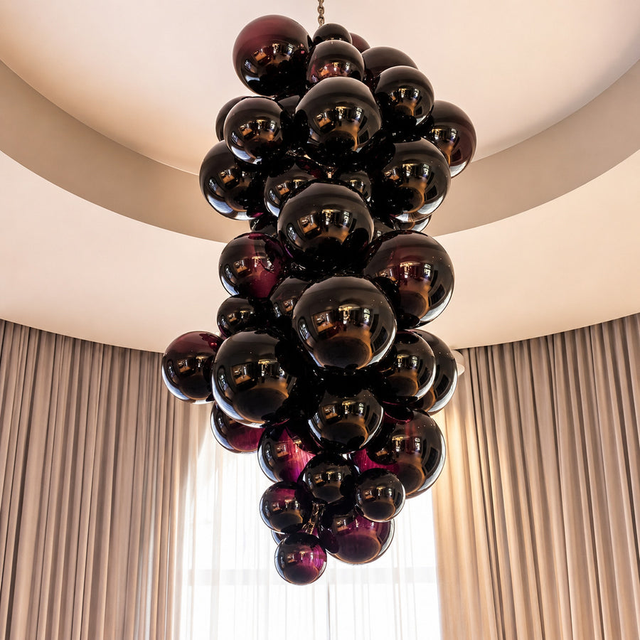 Tall Grappolo glass chandelier cascading in a grand double-height entryway foyer