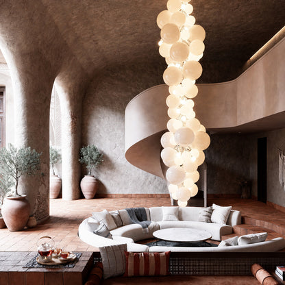 Grand Grappolo glass chandelier anchoring a double-height great room with tall windows