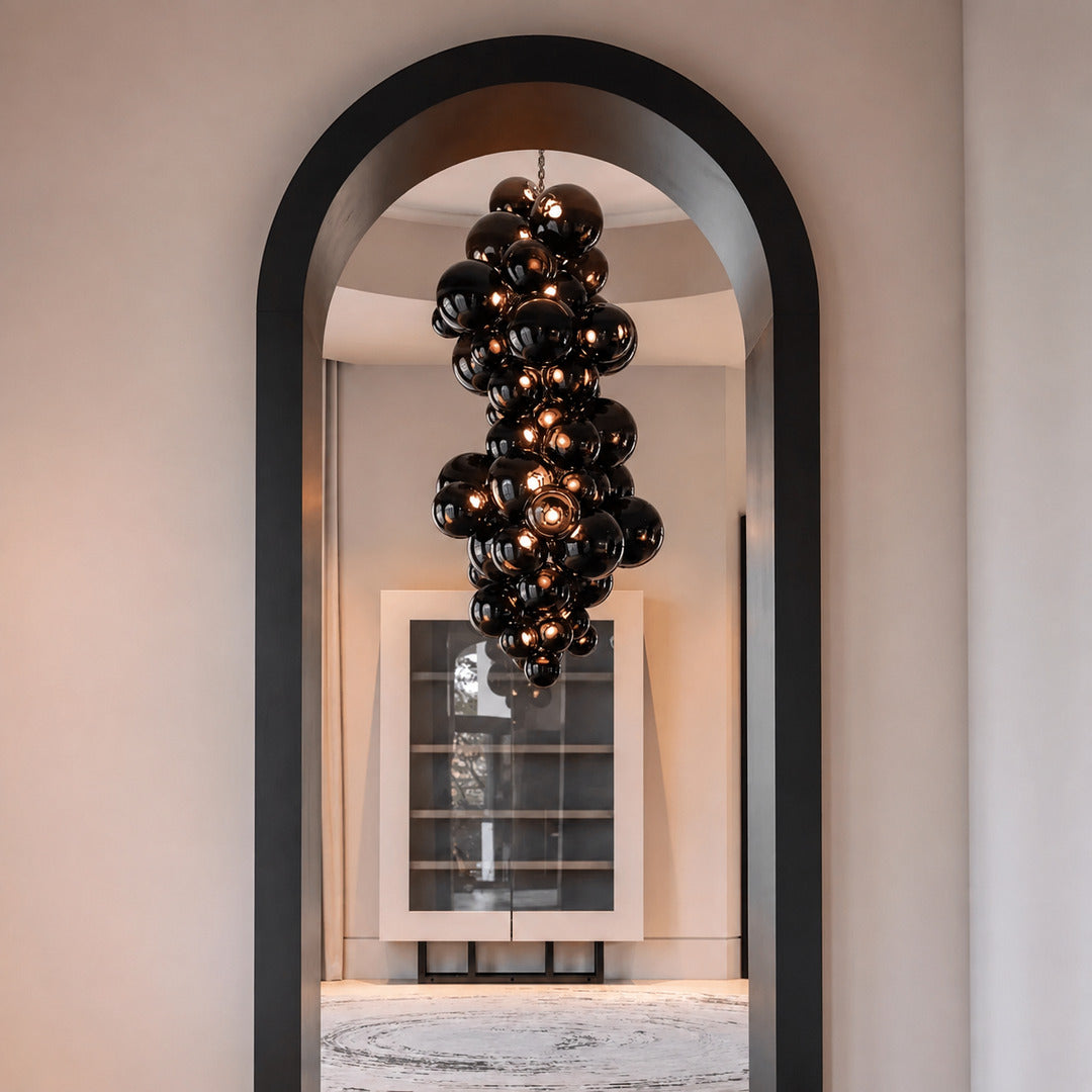 Tall Grappolo glass chandelier cascading in a grand double-height entryway foyer