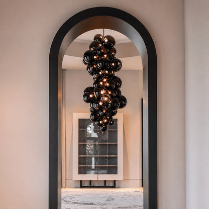 Tall Grappolo glass chandelier cascading in a grand double-height entryway foyer