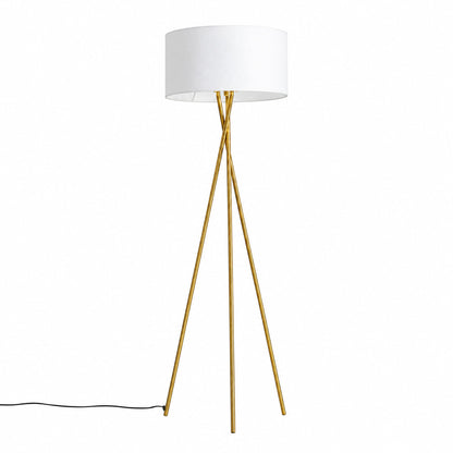 Grazia gold tripod floor lamp with a white fabric shade standing beside a modern sofa