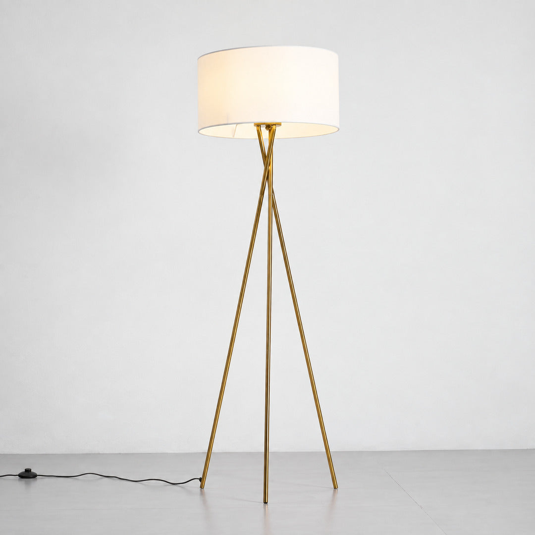 Warm even glow diffusing through the white fabric shade of the Grazia floor lamp