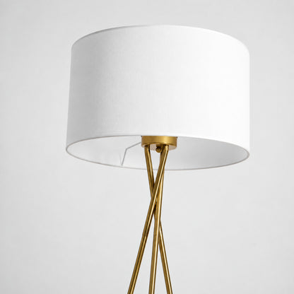 Detail of the soft fabric drum shade in white or linen diffusing a warm glow on the Grazia floor lamp
