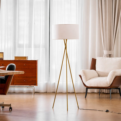 Grazia floor lamp casting a soft warm glow over a corner reading chair
