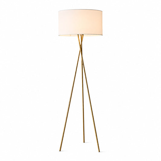Grazia gold tripod floor lamp with a natural linen fabric shade adding warmth beside a sofa