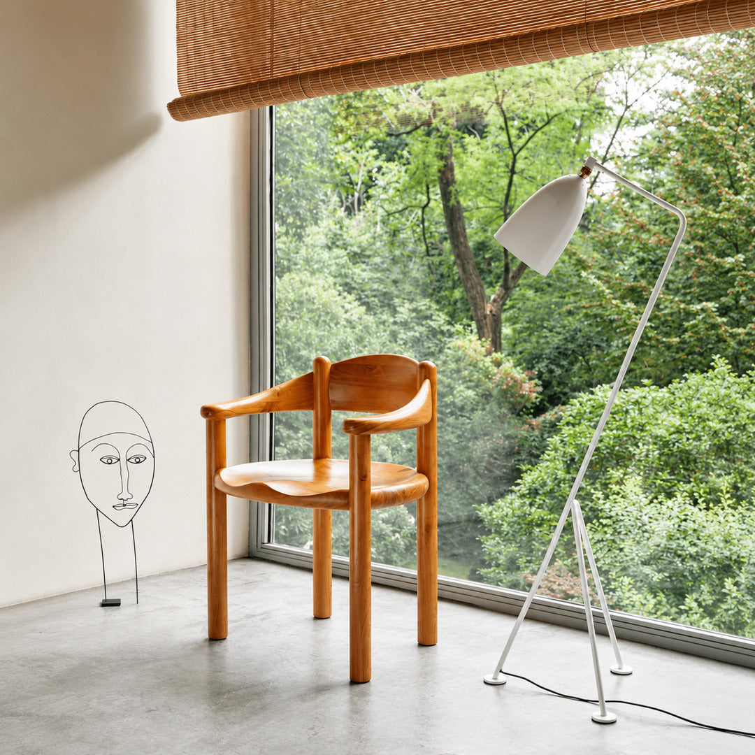 Grillo floor lamp angled over a home office desk for focused task lighting