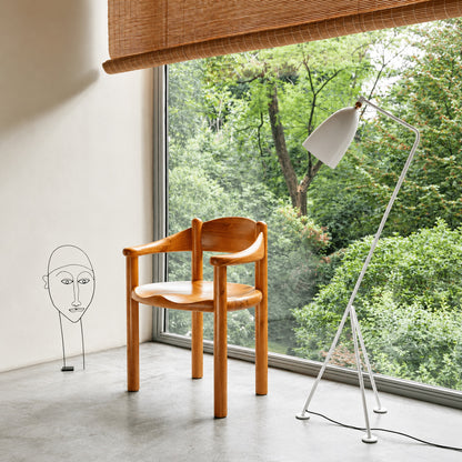 Grillo floor lamp angled over a home office desk for focused task lighting