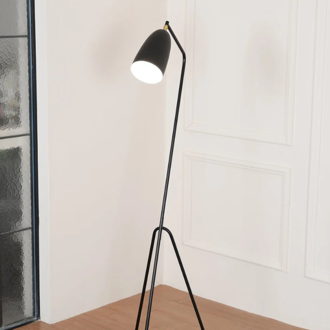 Close-up of the slim angled body of the Grillo floor lamp poised like a grasshopper