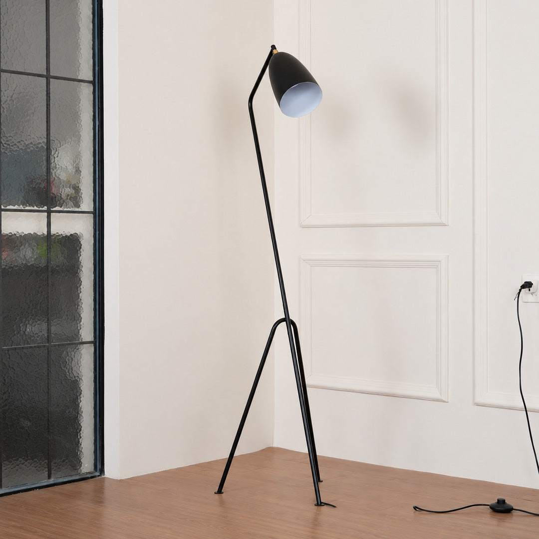 Close-up of the slim angled body of the Grillo floor lamp poised like a grasshopper