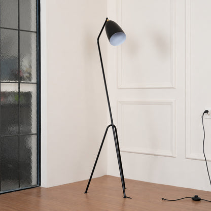 Close-up of the slim angled body of the Grillo floor lamp poised like a grasshopper