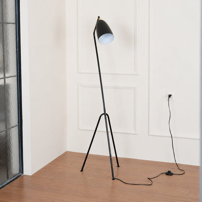 Grillo angled metal floor lamp filling a living room corner with a warm glow